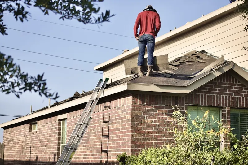 Professional roofer working on a residential roof in Danville